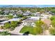 Aerial view of a house with a grassy yard, driveway, and mountain views at 4307 N 15Th Dr, Phoenix, AZ 85015