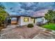 White single-story house with carport, landscaping, and a large front yard at 4307 N 15Th Dr, Phoenix, AZ 85015