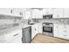 Modern kitchen with white cabinets, marble countertops, and stainless steel appliances at 4307 N 15Th Dr, Phoenix, AZ 85015