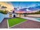 Spacious backyard with a kidney-shaped pool, artificial turf, and a patio at 4307 N 15Th Dr, Phoenix, AZ 85015