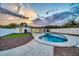 Modern kidney-shaped pool with artificial turf and a large patio at 4307 N 15Th Dr, Phoenix, AZ 85015