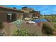 Luxury backyard oasis featuring a pool, spa, and patio furniture at 10308 E Filaree Ln, Scottsdale, AZ 85262