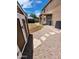 Landscaped backyard with shed, patio, and stone pathway at 6349 W Valencia Dr, Laveen, AZ 85339