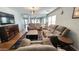 Living room with brown reclining sofas, wood coffee table, and wood floors at 6349 W Valencia Dr, Laveen, AZ 85339