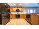 Updated kitchen with stainless steel appliances and wood cabinets at 6349 W Valencia Dr, Laveen, AZ 85339