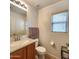 Clean bathroom with a single sink vanity and tile backsplash at 6349 W Valencia Dr, Laveen, AZ 85339