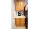 Built-in coffee bar in kitchen with wood cabinets and granite counters at 6349 W Valencia Dr, Laveen, AZ 85339