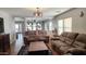 Spacious living room with brown couches, wood coffee table, and wood floors at 6349 W Valencia Dr, Laveen, AZ 85339
