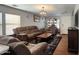 Living room with brown couches, coffee table, and wood floors at 6349 W Valencia Dr, Laveen, AZ 85339