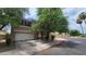 Two-story house with attached garage, landscaping, and neighborhood view at 6349 W Valencia Dr, Laveen, AZ 85339