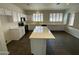 Modern kitchen with white cabinets and large island at 9186 W Clara Ln, Peoria, AZ 85382