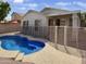 Inviting backyard oasis with a sparkling pool and safety fence at 9186 W Clara Ln, Peoria, AZ 85382