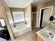 Main bathroom with soaking tub, shower and double vanity at 15257 W Monroe St, Goodyear, AZ 85338