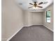 Bright bedroom with carpet and ceiling fan at 42054 W Cheyenne Dr, Maricopa, AZ 85138