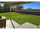 Spacious backyard with grassy lawn, patio, and mountain views at 35066 N Happy Jack Dr, San Tan Valley, AZ 85144