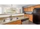 Kitchen with light wood cabinets, granite countertops, and double sink at 35066 N Happy Jack Dr, San Tan Valley, AZ 85144