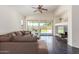 Living room with L-shaped sofa, ceiling fan, and sliding glass doors to backyard at 35066 N Happy Jack Dr, San Tan Valley, AZ 85144