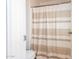 Clean bathroom with shower/tub and striped shower curtain at 35066 N Happy Jack Dr, San Tan Valley, AZ 85144