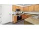 Kitchen with light wood cabinets, stainless steel appliances, and granite countertops at 35066 N Happy Jack Dr, San Tan Valley, AZ 85144