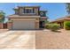 Two-story home with gray exterior, stone accents, and a two-car garage at 35066 N Happy Jack Dr, San Tan Valley, AZ 85144
