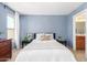 Well-lit bedroom with a queen bed and ensuite bathroom at 35066 N Happy Jack Dr, San Tan Valley, AZ 85144