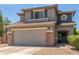 Two-story home with gray exterior, stone accents, and a two-car garage at 35066 N Happy Jack Dr, San Tan Valley, AZ 85144