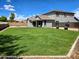Large grassy backyard with covered patio and two-story home at 35066 N Happy Jack Dr, San Tan Valley, AZ 85144