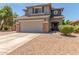 Two-story house with gray siding, stone accents, and a two-car garage at 35066 N Happy Jack Dr, San Tan Valley, AZ 85144