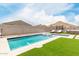 Sparkling pool with artificial turf and mountain views at 4455 W Suncup Dr, San Tan Valley, AZ 85144