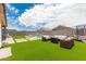 Spacious backyard with pool, artificial turf, and seating area at 4455 W Suncup Dr, San Tan Valley, AZ 85144