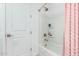 Bright bathroom with white tub and shower, and pink curtain at 4455 W Suncup Dr, San Tan Valley, AZ 85144