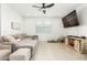 Spacious living room featuring a large sectional sofa and TV at 4455 W Suncup Dr, San Tan Valley, AZ 85144