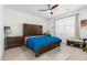 Bedroom with a king bed, wood headboard, and window seat at 4455 W Suncup Dr, San Tan Valley, AZ 85144