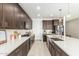 Modern kitchen with white quartz countertops and dark brown cabinetry at 4455 W Suncup Dr, San Tan Valley, AZ 85144