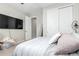 Bedroom with a queen bed, large TV, and walk-in closet at 4455 W Suncup Dr, San Tan Valley, AZ 85144