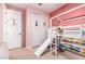 bedroom with bunk bed, slide, and pink walls at 4455 W Suncup Dr, San Tan Valley, AZ 85144