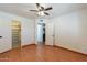 Bedroom with wood floors, double doors to closet, and access to other rooms at 14602 N Olympic Way, Fountain Hills, AZ 85268