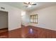Bedroom with hardwood floors, ceiling fan, and double door closet at 14602 N Olympic Way, Fountain Hills, AZ 85268