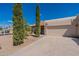 Tan stucco house with a two-car garage and neatly trimmed trees at 14602 N Olympic Way, Fountain Hills, AZ 85268