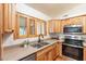 Kitchen with light wood cabinets, stainless steel appliances, and a double sink at 14602 N Olympic Way, Fountain Hills, AZ 85268