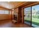 Sunroom with stone fireplace, wood walls and backyard access at 14602 N Olympic Way, Fountain Hills, AZ 85268