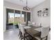 Dining area with a table for six and sliding glass doors to backyard at 14634 W Wethersfield Rd, Surprise, AZ 85379