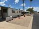 Side view of manufactured home showing landscaping and street at 652 S Ellsworth Rd # 90, Mesa, AZ 85208