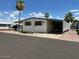 Front view of a well-maintained manufactured home with carport at 652 S Ellsworth Rd # 90, Mesa, AZ 85208