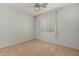 Bright bedroom featuring a ceiling fan and window with curtains at 42425 W North Star Dr, Maricopa, AZ 85138