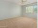 Bright bedroom with ceiling fan and window blinds at 42425 W North Star Dr, Maricopa, AZ 85138
