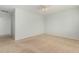 Spacious bedroom with neutral carpeting and an adjacent hallway at 42425 W North Star Dr, Maricopa, AZ 85138