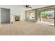 Spacious living room with fireplace and sliding glass doors at 42425 W North Star Dr, Maricopa, AZ 85138