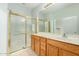 Bathroom boasts double sinks, wood cabinets, and a shower at 42425 W North Star Dr, Maricopa, AZ 85138