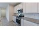 Modern kitchen with white cabinets and granite countertops at 21553 W Papago St, Buckeye, AZ 85326